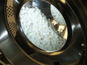 Batch of tablets in a pan coater, part of Upperton's tablet formulation development services